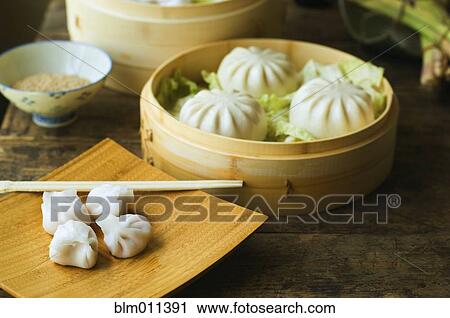 Stock Image - Asian dumpling in steamer with cabbage. Fotosearch