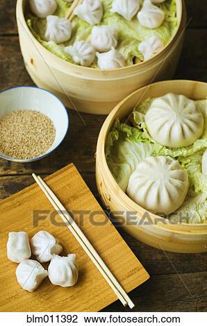 Stock Image - Asian dumpling in steamer with cabbage. Fotosearch