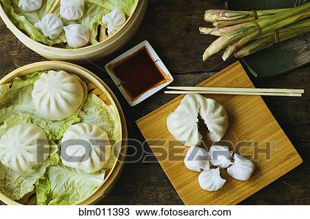 Stock Image - Asian dumpling in steamer with cabbage. Fotosearch