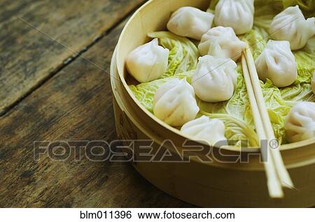 Asian dumpling in steamer with cabbage View Large Photo Image Stock Photograph - Asian dumpling in steamer with cabbage. Fotosearch