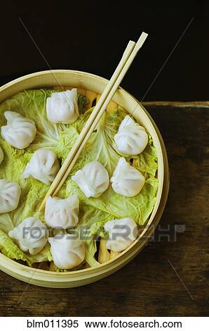 Stock Photography - Asian dumpling in steamer with cabbage. Fotosearch