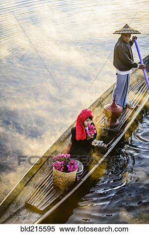 Asian farmer and daughter rowing in canoe on river View Large Photo Image Stock Photography - Asian farmer and daughter rowing in canoe on river. Fotosearch
