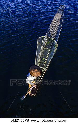 Asian fisherman fishing in canoe on river View Large Photo Image Stock Photo - Asian fisherman fishing in canoe on river. Fotosearch
