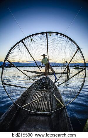 Asian fisherman using fishing net in canoe on river View Large Photo Image Stock Image - Asian fisherman using fishing net in canoe on river. Fotosearch