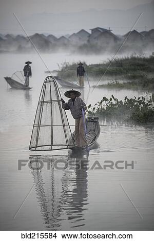 Picture - Asian fishermen fishing in canoes on river. Fotosearch