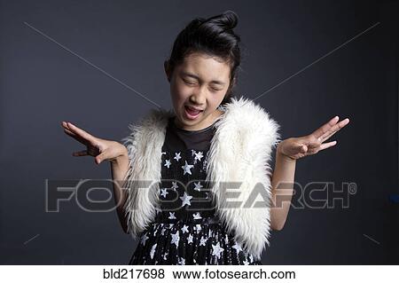 Asian girl dancing in furry vest View Large Photo Image Stock Photo - Asian girl dancing in furry vest. Fotosearch