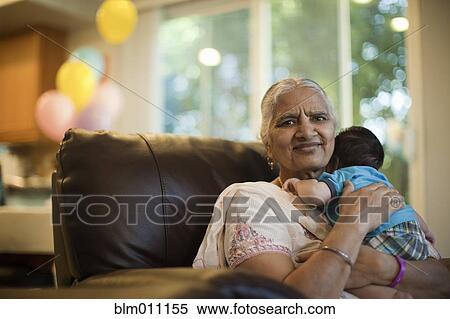 Stock Photography - Asian grandmother comforting baby boy. Fotosearch