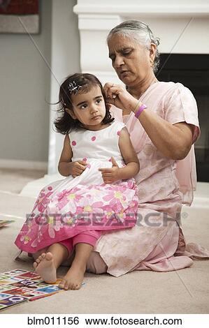 Asian grandmother fixing granddaughter's hair View Large Photo Image Stock Photograph - Asian grandmother fixing granddaughter's hair. Fotosearch