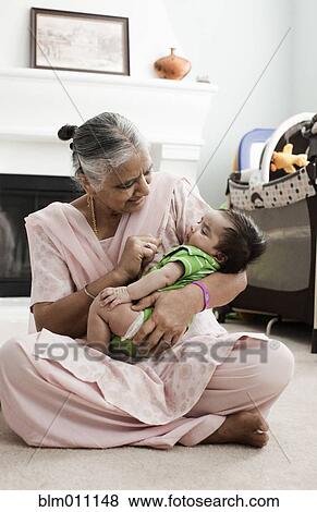 Stock Photo - Asian grandmother holding baby boy. Fotosearch