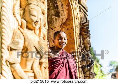 Asian monk-in-training peering around carved temple walls View Large Photo Image Stock Photography - Asian monk-in-training peering around carved temple walls. Fotosearch