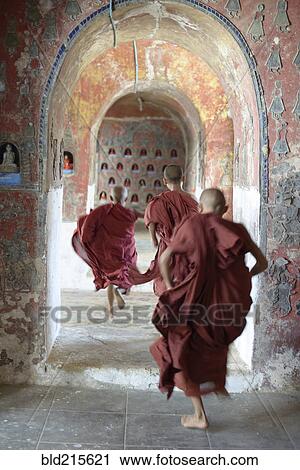 Asian monks-in-training running in dilapidated temple hallway View Large Photo Image Stock Image - Asian monks-in-training running in dilapidated temple hallway. Fotosearch