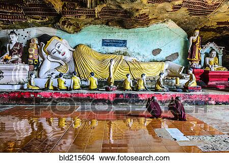 Asian monks praying to Buddha statue in temple View Large Photo Image Picture - Asian monks praying to Buddha statue in temple. Fotosearch