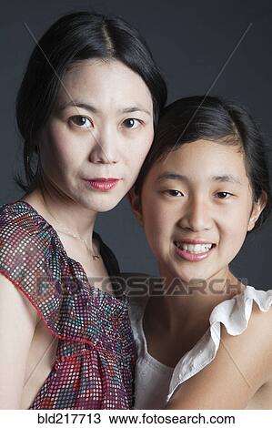 Asian mother and daughter hugging View Large Photo Image Stock Image - Asian mother and daughter hugging. Fotosearch