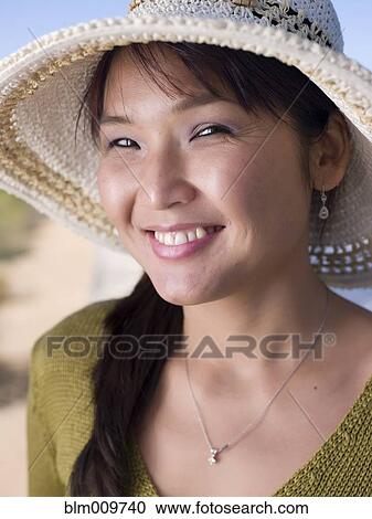 Asian woman in hat smiling View Large Photo Image Stock Image - Asian woman in hat smiling. Fotosearch