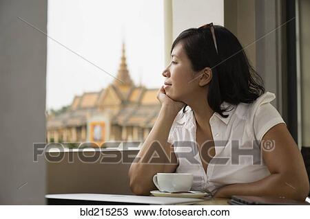 Asian woman looking out cafe window, Phnom Penh, Cambodia View Large Photo Image Stock Image - Asian woman looking out cafe window, Phnom Penh, Cambodia. Fotosearch