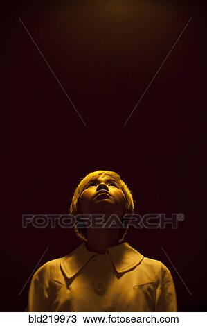 Stock Image - Asian woman looking up. Fotosearch
