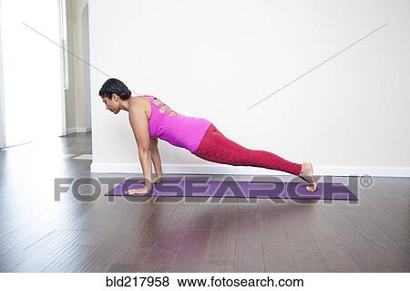 Stock Photo - Asian woman practicing yoga in studio. Fotosearch