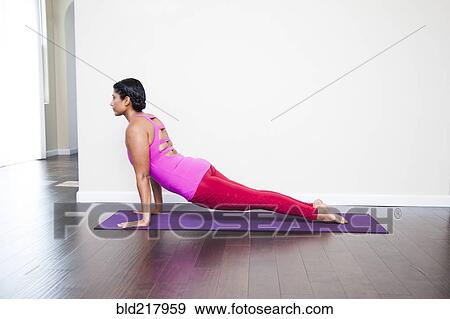 Asian woman practicing yoga in studio View Large Photo Image Stock Photo - Asian woman practicing yoga in studio. Fotosearch