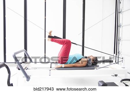 Asian woman using exercise machine in gymnasium View Large Photo Image Stock Image - Asian woman using exercise machine in gymnasium. Fotosearch