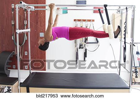 Asian woman using exercise machine in gymnasium View Large Photo Image Stock Image - Asian woman using exercise machine in gymnasium. Fotosearch