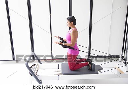 Asian woman using exercise machine in gymnasium View Large Photo Image Stock Photograph - Asian woman using exercise machine in gymnasium. Fotosearch