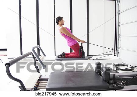 Asian woman using exercise machine in gymnasium View Large Photo Image Stock Photography - Asian woman using exercise machine in gymnasium. Fotosearch