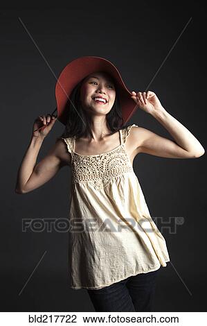 Asian woman wearing red hat View Large Photo Image Stock Image - Asian woman wearing red hat. Fotosearch