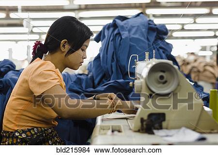 Asian worker sewing clothing in garment factory View Large Photo Image Picture - Asian worker sewing clothing in garment factory. Fotosearch