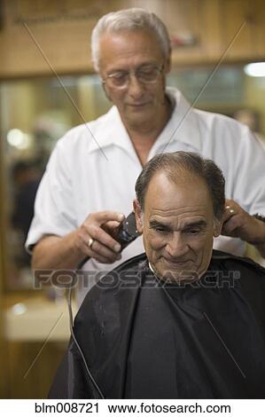 Barber cutting customer's hair in barbershop View Large Photo Image Stock Image - Barber cutting customer's hair in barbershop. Fotosearch