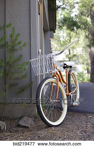 Bicycle leaning on corner of house View Large Photo Image Stock Photo - Bicycle leaning on corner of house. Fotosearch