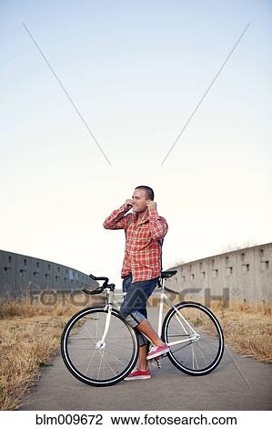 Bicycle messenger stopping on urban path View Large Photo Image Stock Image - Bicycle messenger stopping on urban path. Fotosearch