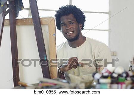 Stock Photography - Black artist painting in art studio. Fotosearch