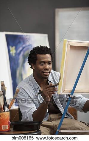Black artist painting on easel View Large Photo Image Stock Photography - Black artist painting on easel. Fotosearch