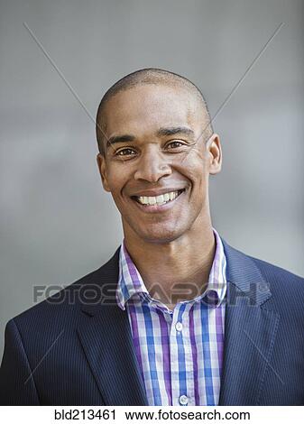 Stock Image - Black businessman smiling. Fotosearch