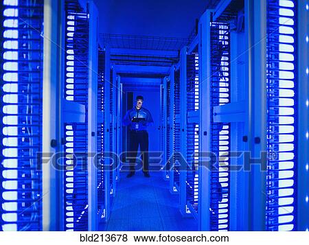 Black businessman using digital tablet in server room View Large Photo Image Stock Photo - Black businessman using digital tablet in server room. Fotosearch