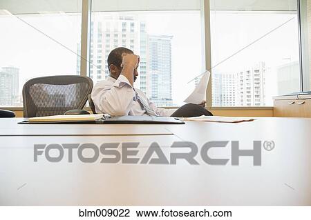 Black businessman working at conference table View Large Photo Image Stock Image - Black businessman working at conference table. Fotosearch