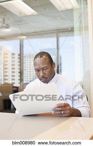 Stock Image - Black businessman working in office. Fotosearch