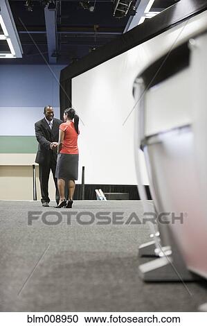 Black businesspeople shaking hands on stage View Large Photo Image Stock Image - Black businesspeople shaking hands on stage. Fotosearch