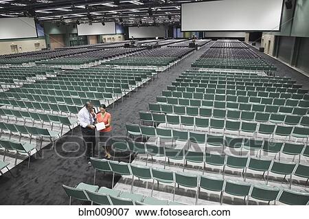 Black businesspeople talking in empty conference center View Large Photo Image Stock Photo - Black businesspeople talking in empty conference center. Fotosearch