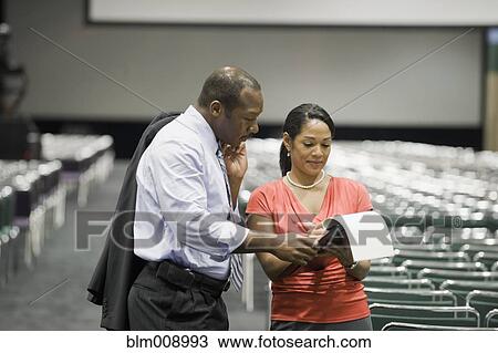 Stock Image - Black businesspeople talking in conference center. Fotosearch