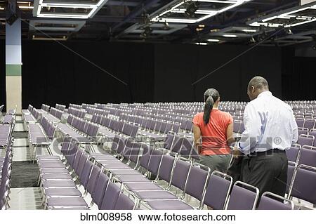 Stock Photo - Black businesspeople waiting in empty conference center. Fotosearch