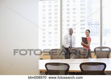 Stock Image - Black businesspeople working in conference room. Fotosearch