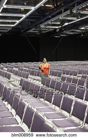 Black businesswoman waiting in empty conference center View Large Photo Image Stock Photo - Black businesswoman waiting in empty conference center. Fotosearch