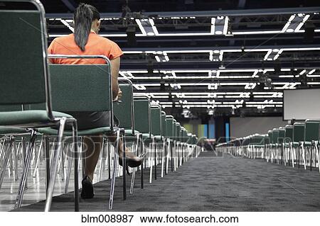 Black businesswoman waiting in empty conference center View Large Photo Image Stock Photo - Black businesswoman waiting in empty conference center. Fotosearch