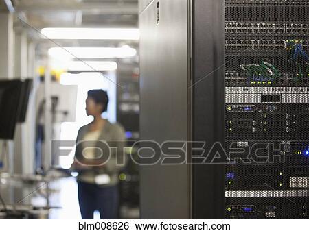 Stock Photograph - Black businesswoman working in office technology room. Fotosearch