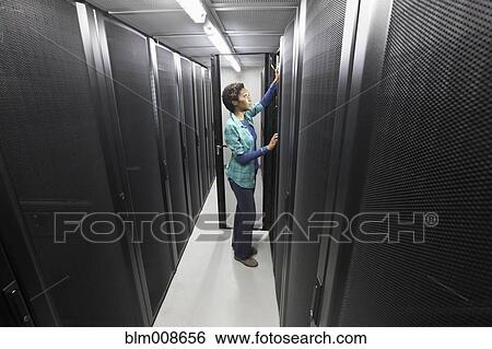 Stock Photograph - Black businesswoman working in office technology room. Fotosearch