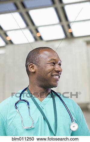 Black doctor standing in lobby View Large Photo Image Stock Image - Black doctor standing in lobby. Fotosearch