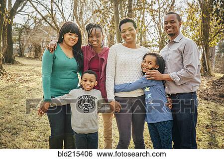 Stock Photograph - Black family smiling outdoors. Fotosearch