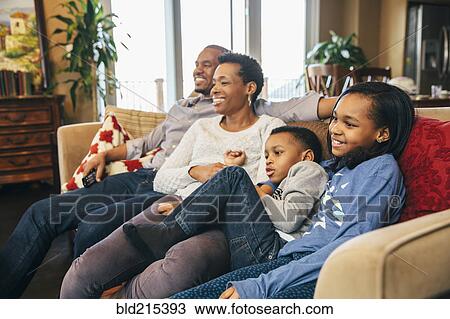 Black family watching television on sofa View Large Photo Image Stock Image - Black family watching television on sofa. Fotosearch