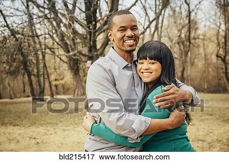 Black father and daughter hugging outdoors View Large Photo Image Stock Photo - Black father and daughter hugging outdoors. Fotosearch
